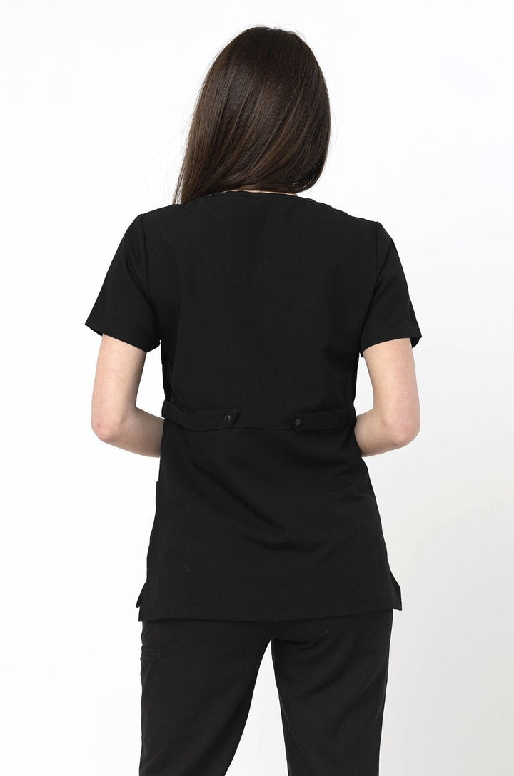 Back view of black breastfeeding scrubs worn by nursing mom. 