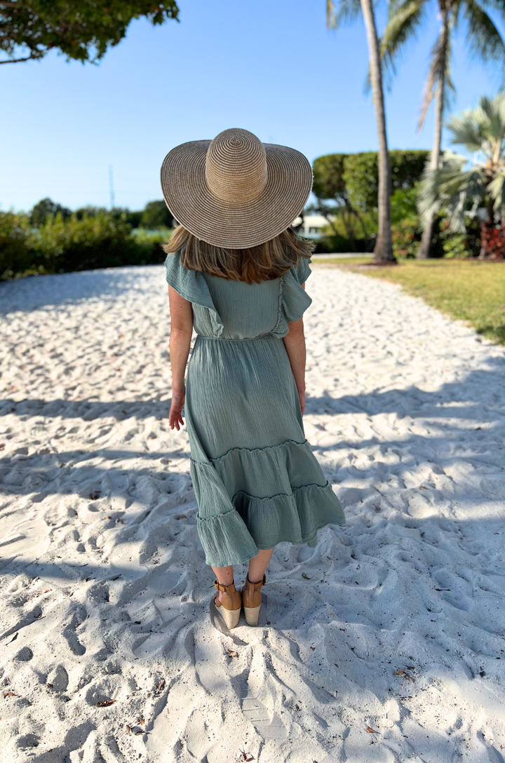 A back view shows a mom in the seafoam green gauze midi breastfeeding dress with a smooth silhouette and comfortable coverage.