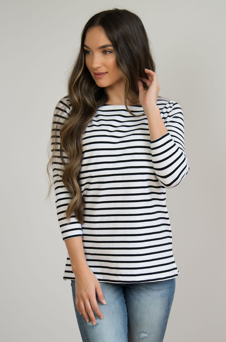 Woman wearing striped nursing top with hidden zipper access for breastfeeding